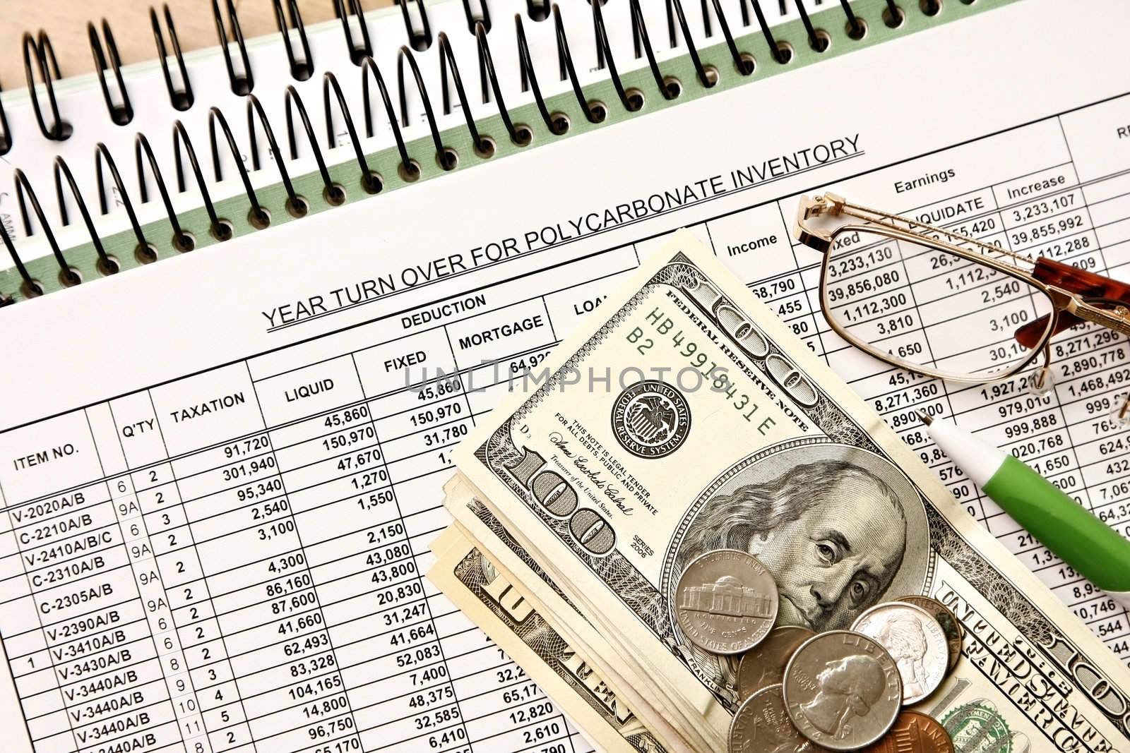 Spreadsheet with dollar financial figures and glasses