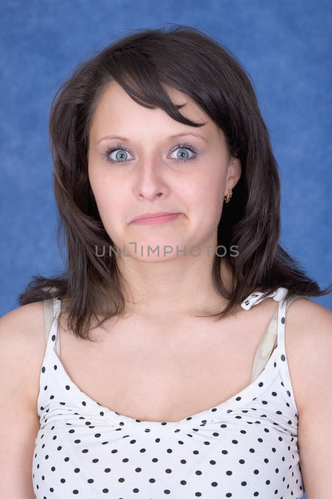 The amazed girl on a blue background