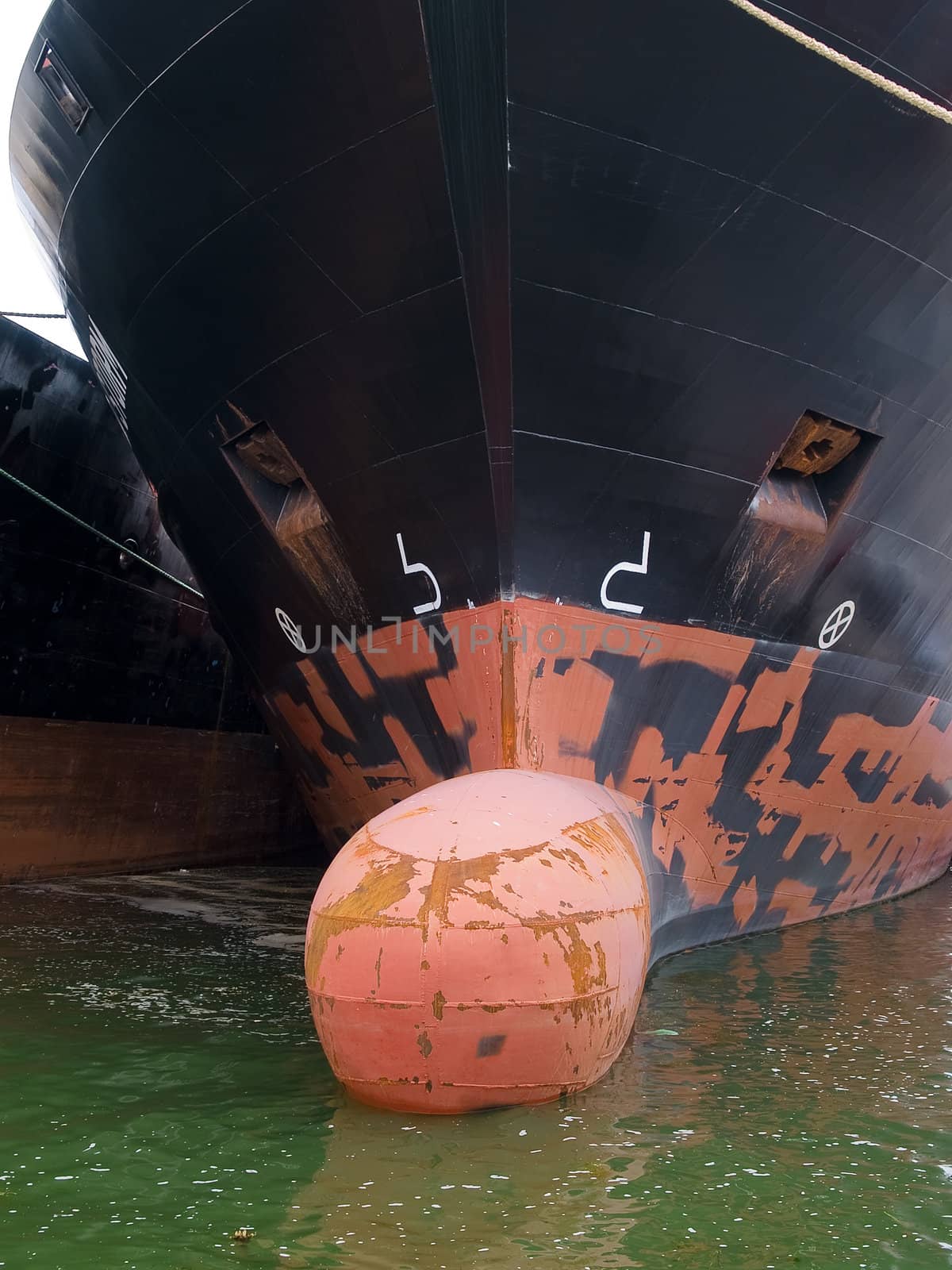 Commercial Cargo boat moored to a dock in a port vertical