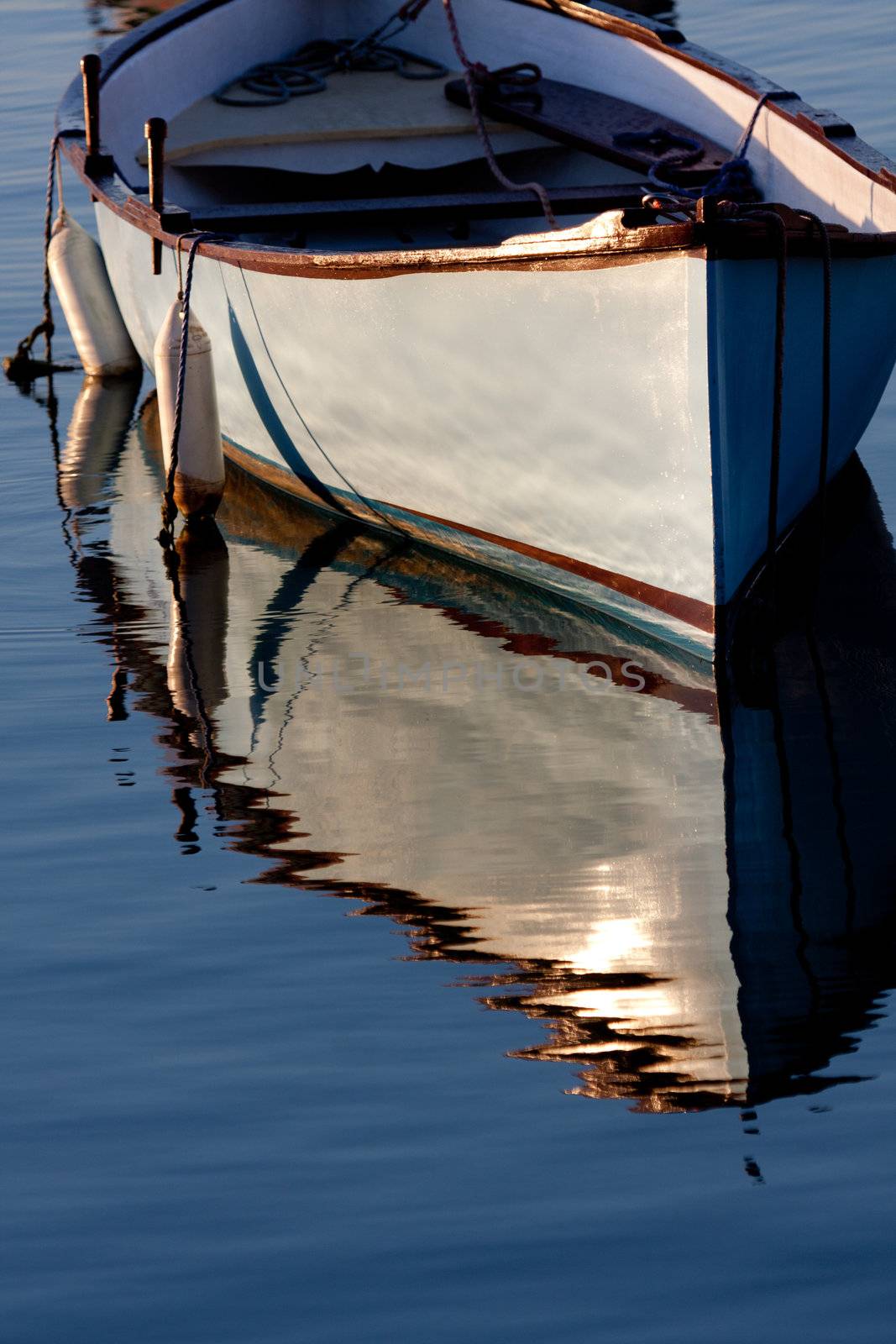 Morning light on a grey boat at anchor