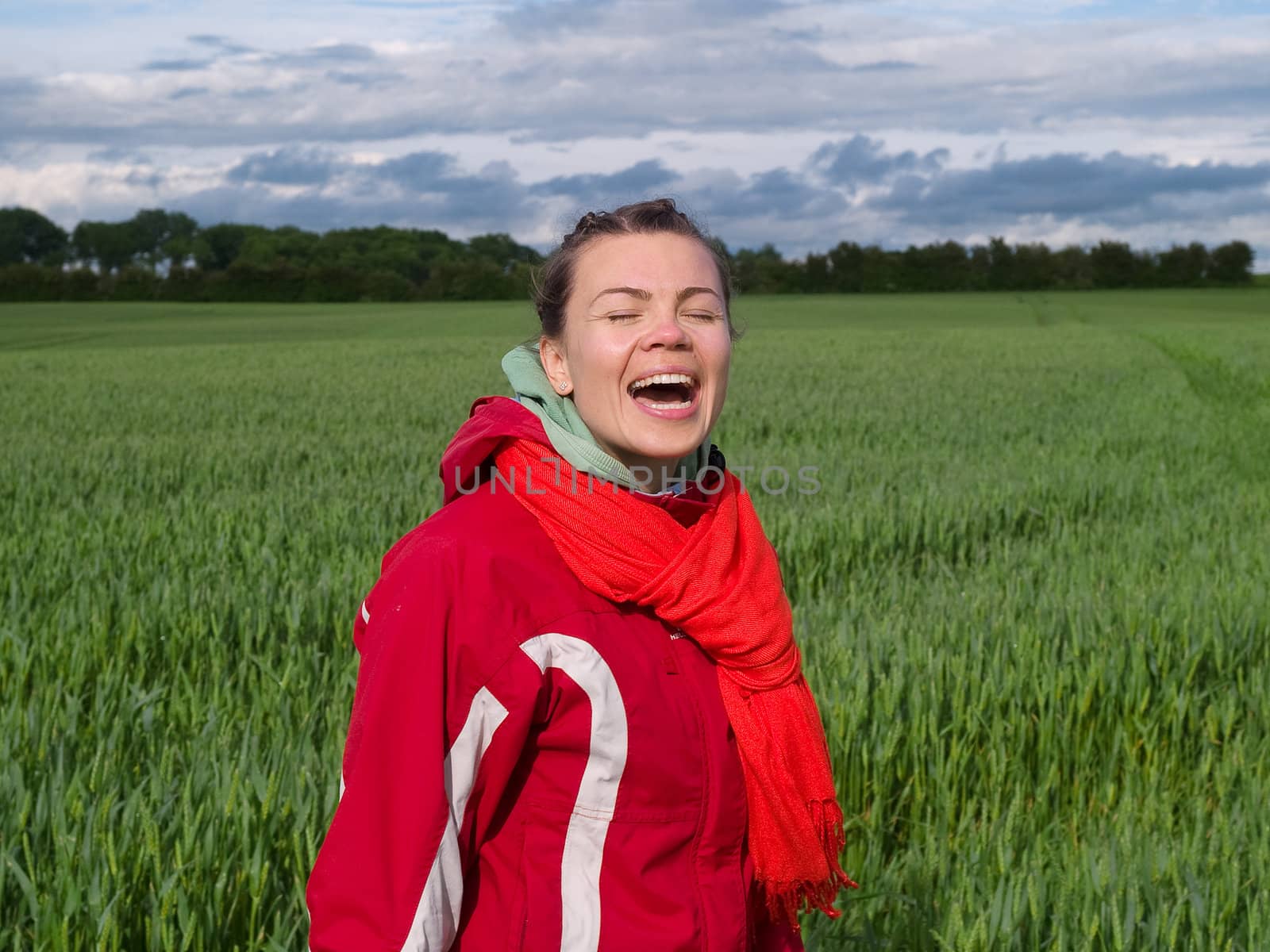 Beautiful attractive smiling young happy woman girl in a green wheat field