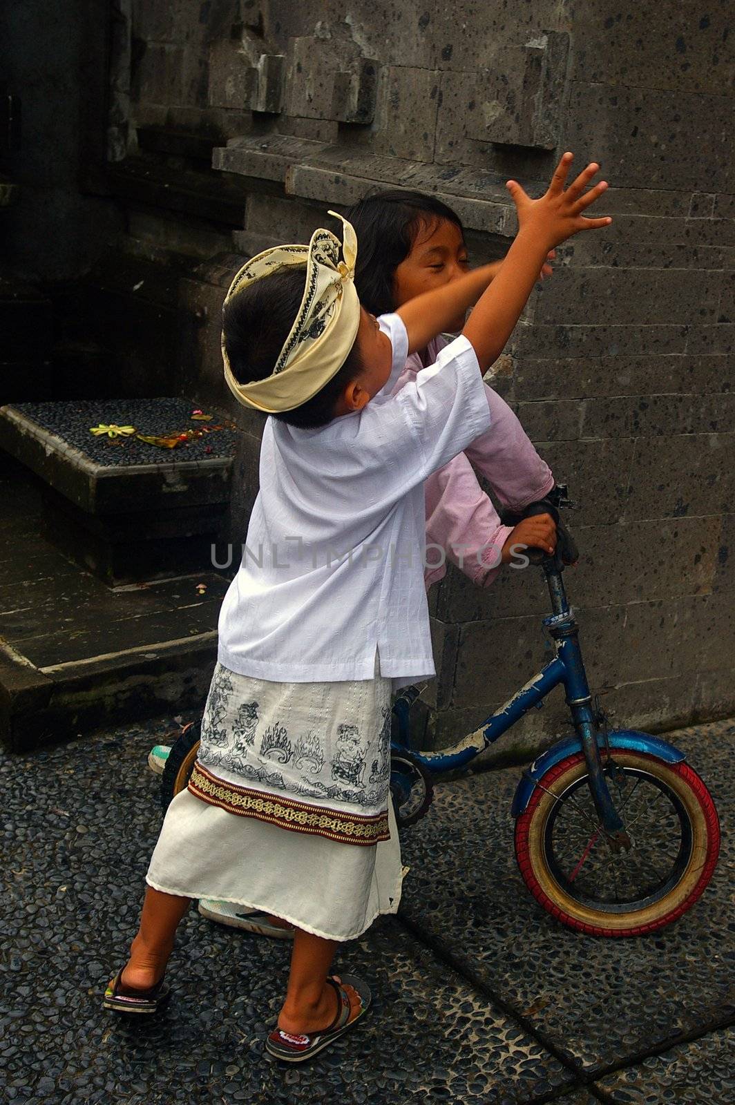 Balinese children playing in the street, Jimbaran, Bali, Indonesia.