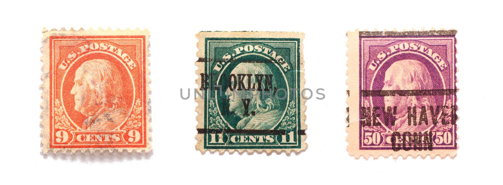 Three Benjamin Franklin US postal stamps in different values and colors.