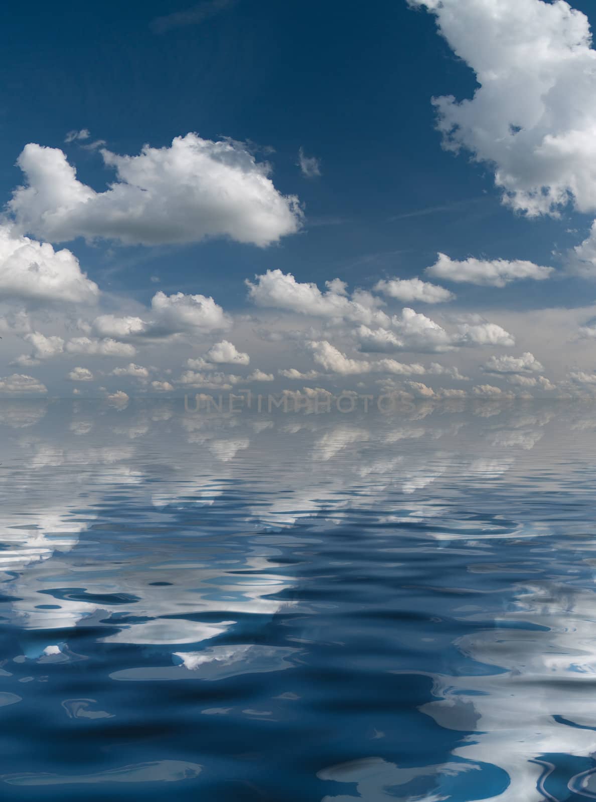 White clouds on a clear blue sky mirrored in rippled water