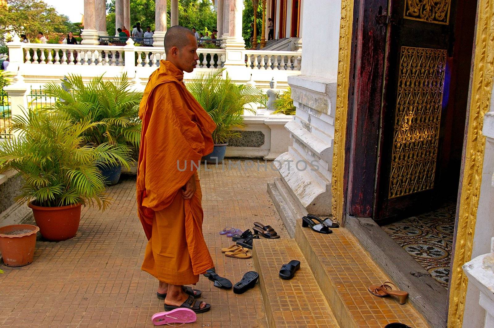 A Buddhist monk entering a place of worship at the Royal Palace, Phnom Penh, Cambodia.