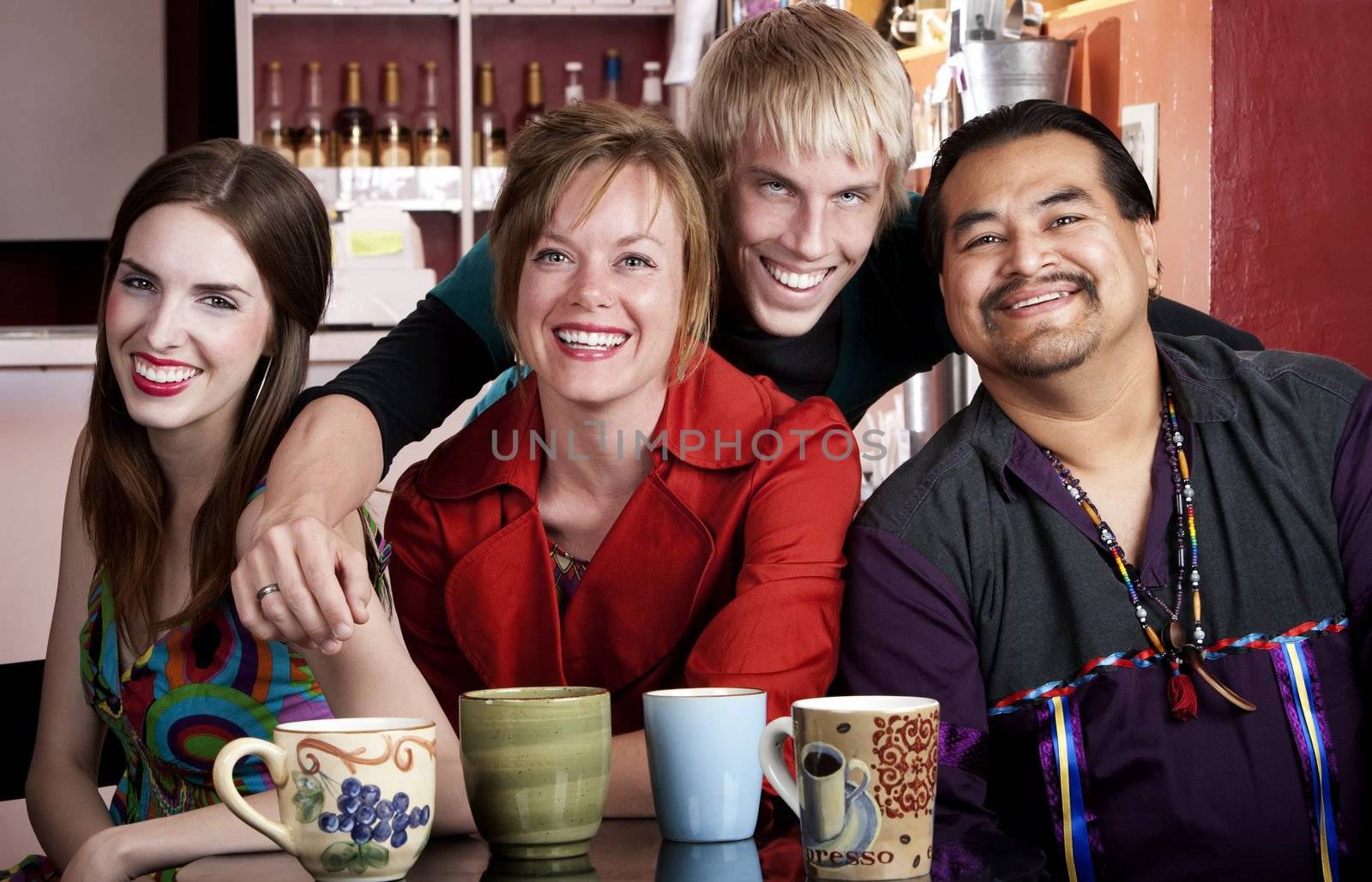 Four friends posing in a coffee house