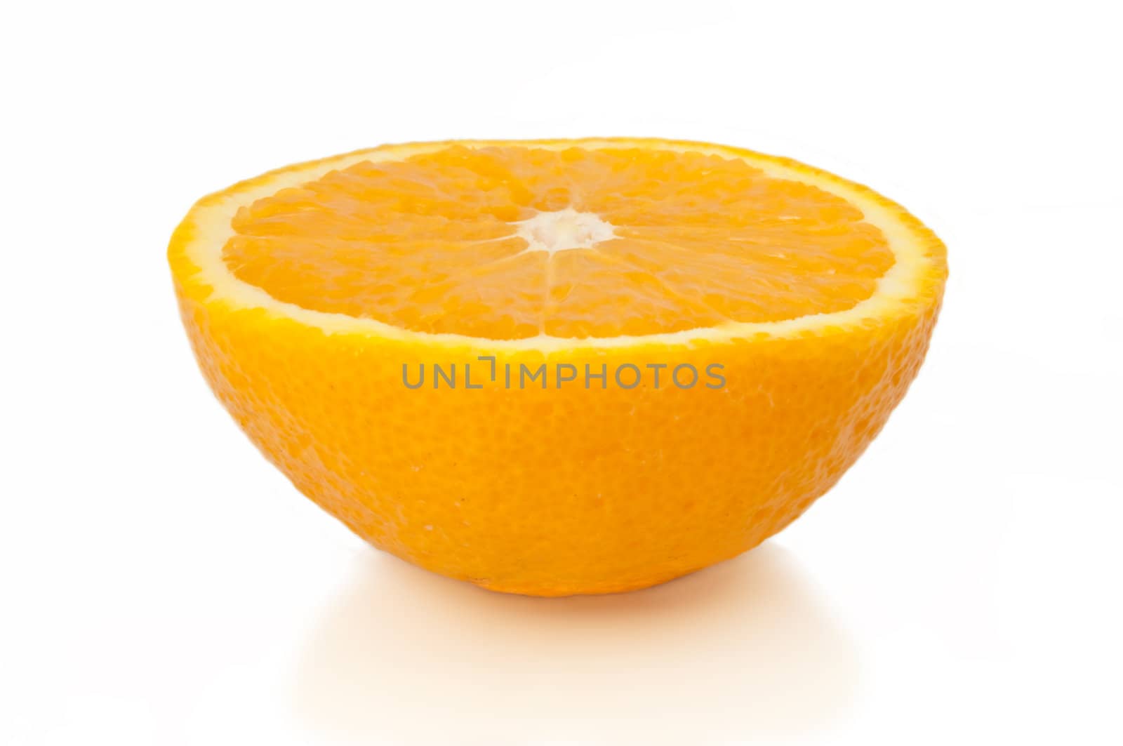 Close and low level capturing half an orange isolated over white.