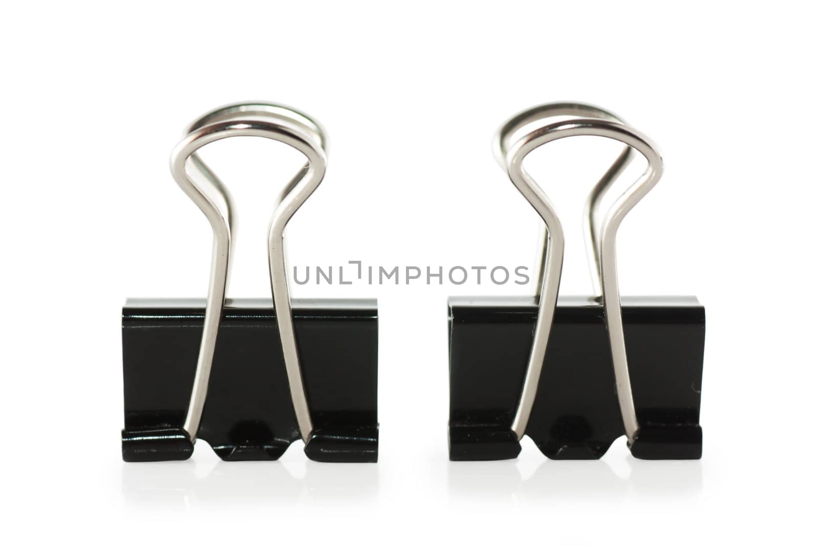 Black metal paperclips on white background
