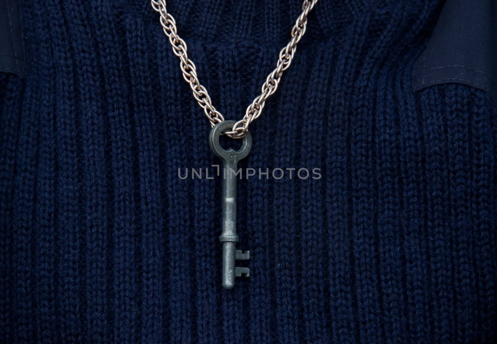 A child wears a key around the neck