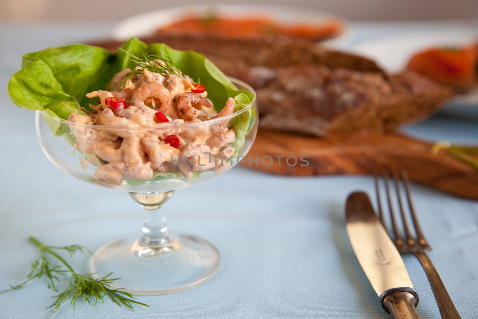 Shrimps salad in a cocktail glass as appetizer