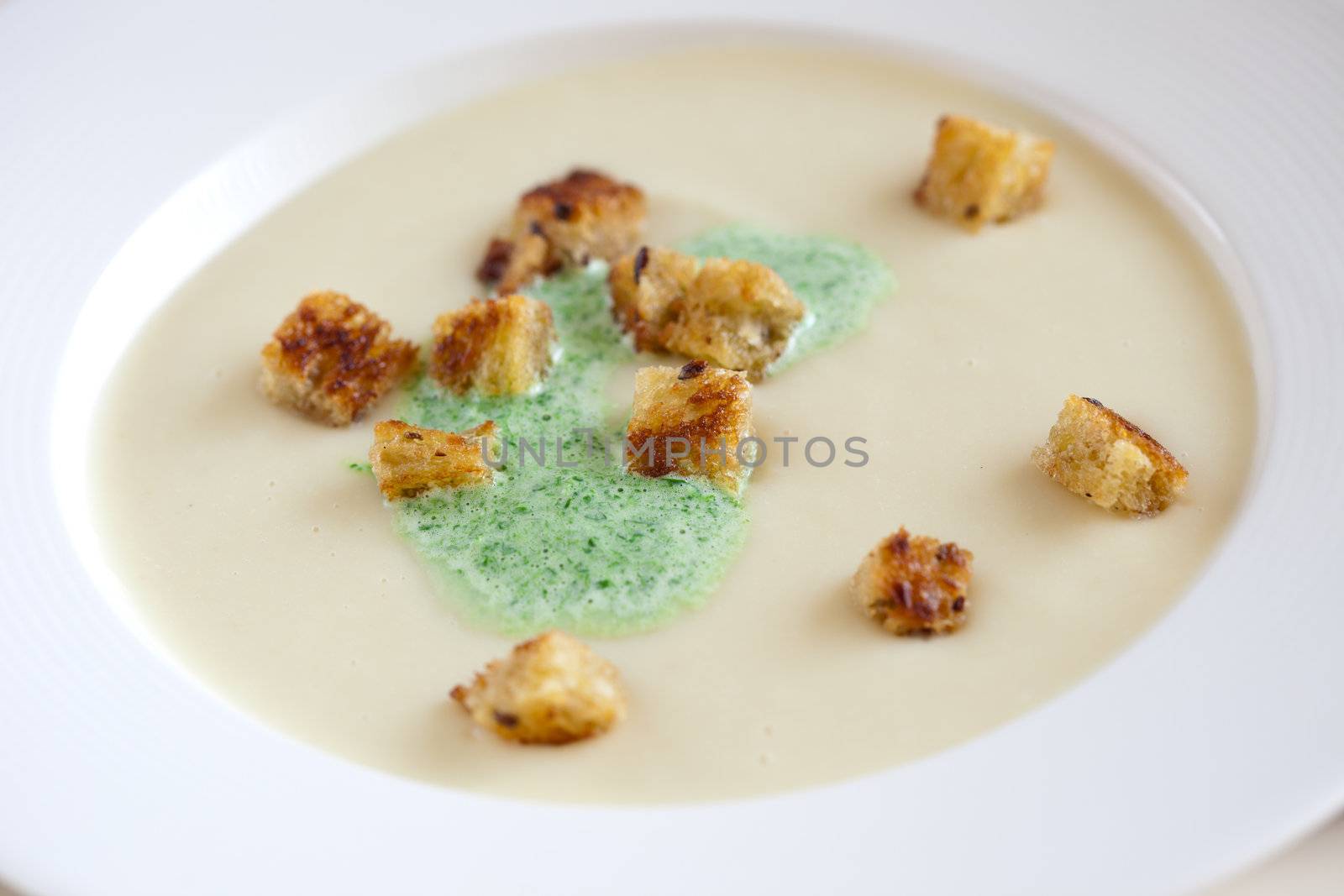 Delicious soup with parsnips and parsley cream on top