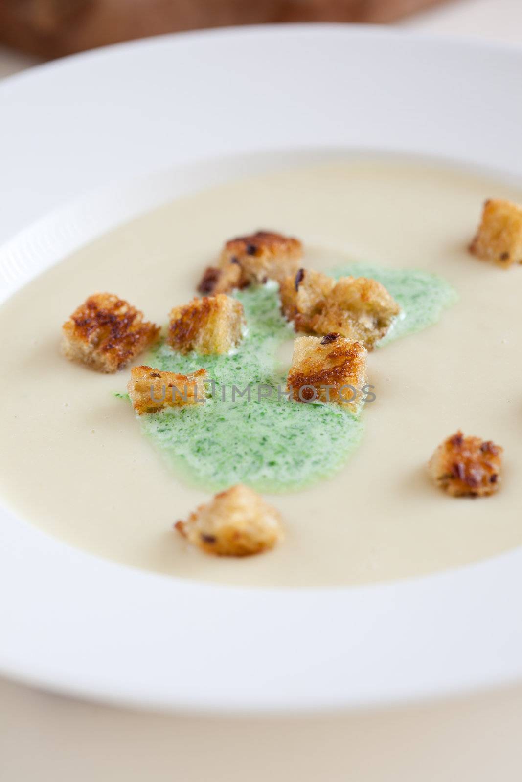Delicious parsnip soup with parsley cream and croutons