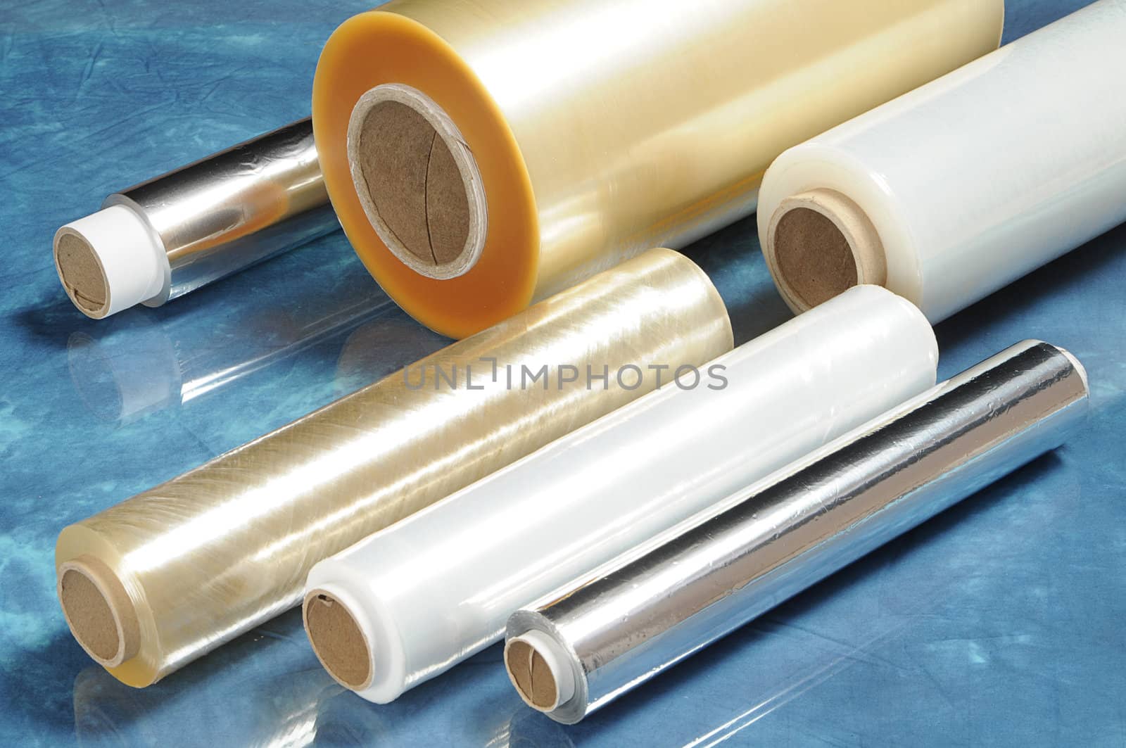 Rolls of film for vacuum packaging of foods and food foil