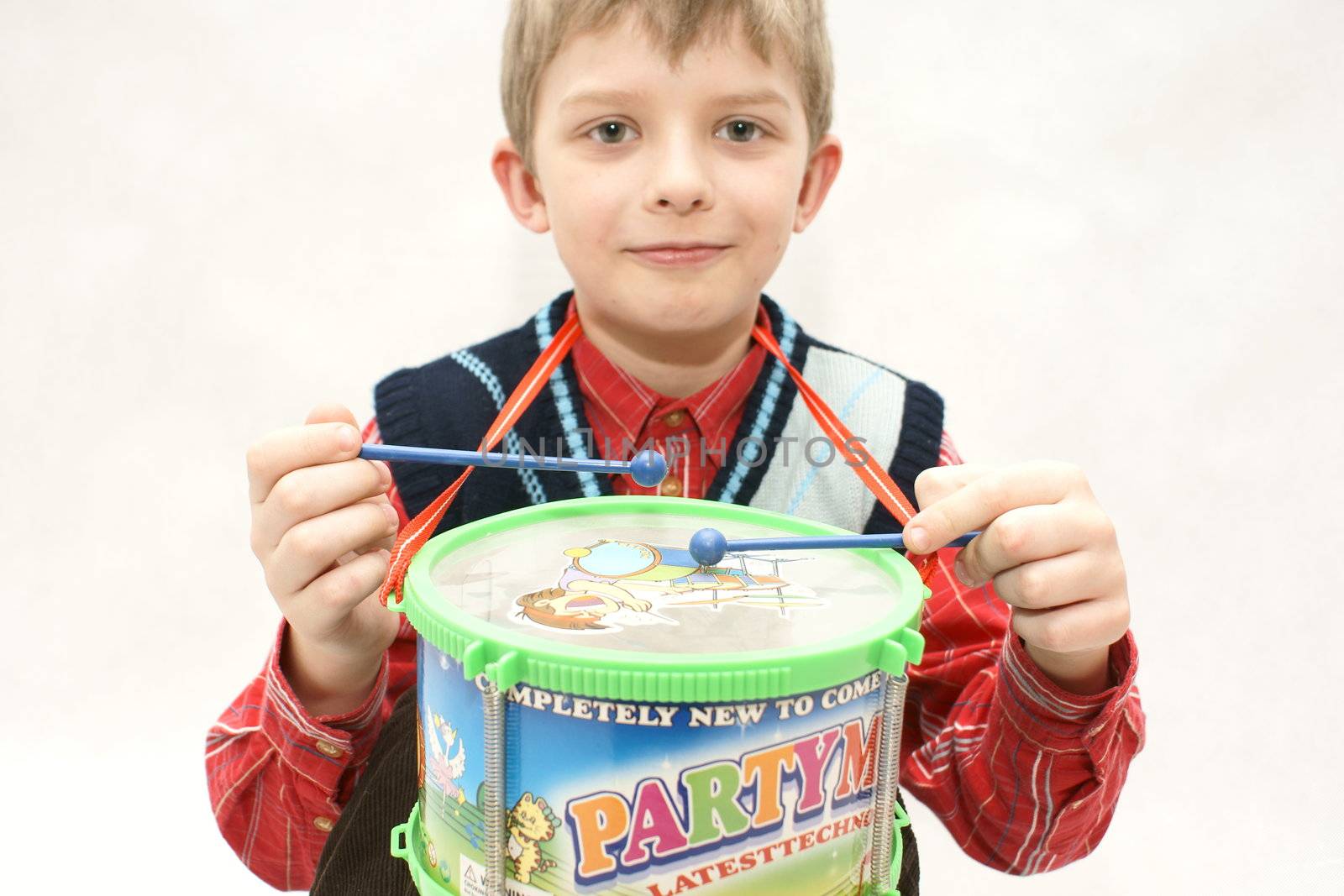 young boy with drums in white background