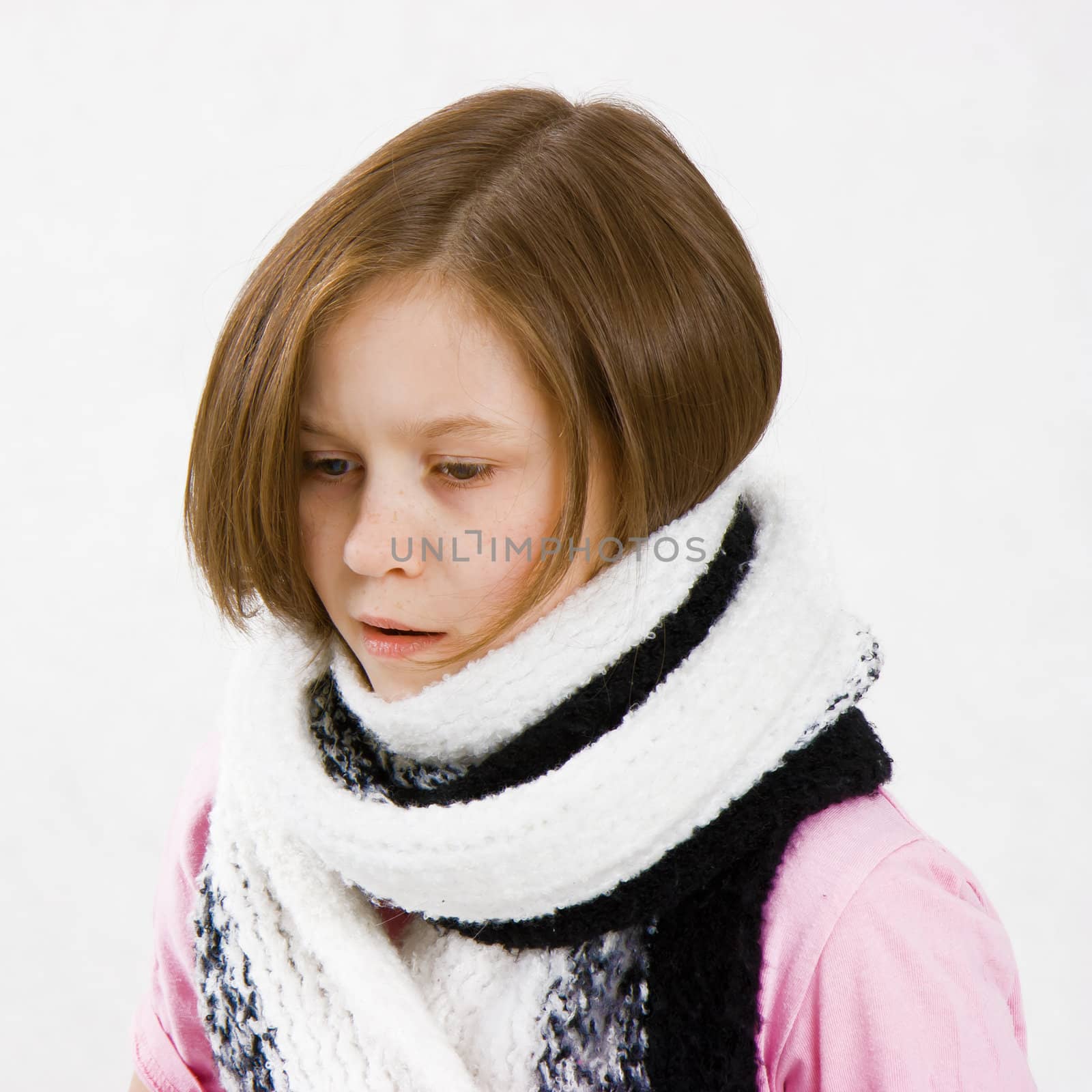 Teen girl wearing a scarf with a thermometer in her mouth