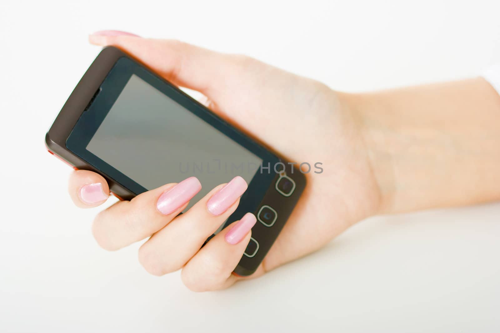 woman's hand with a mobile phone on a light background
