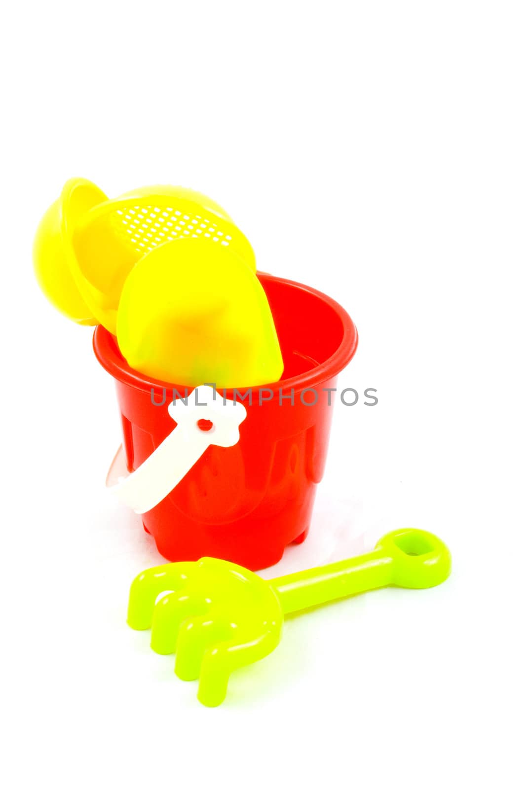Red bucket and toys, isolated on white background by ladyminnie