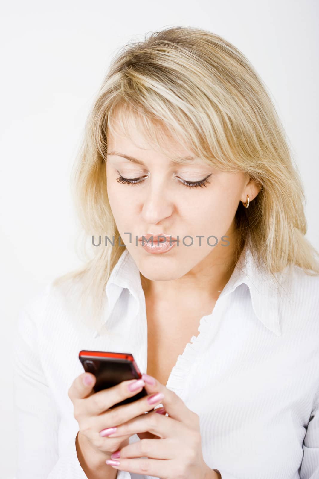 portrait of blonde girl with a mobile phone
