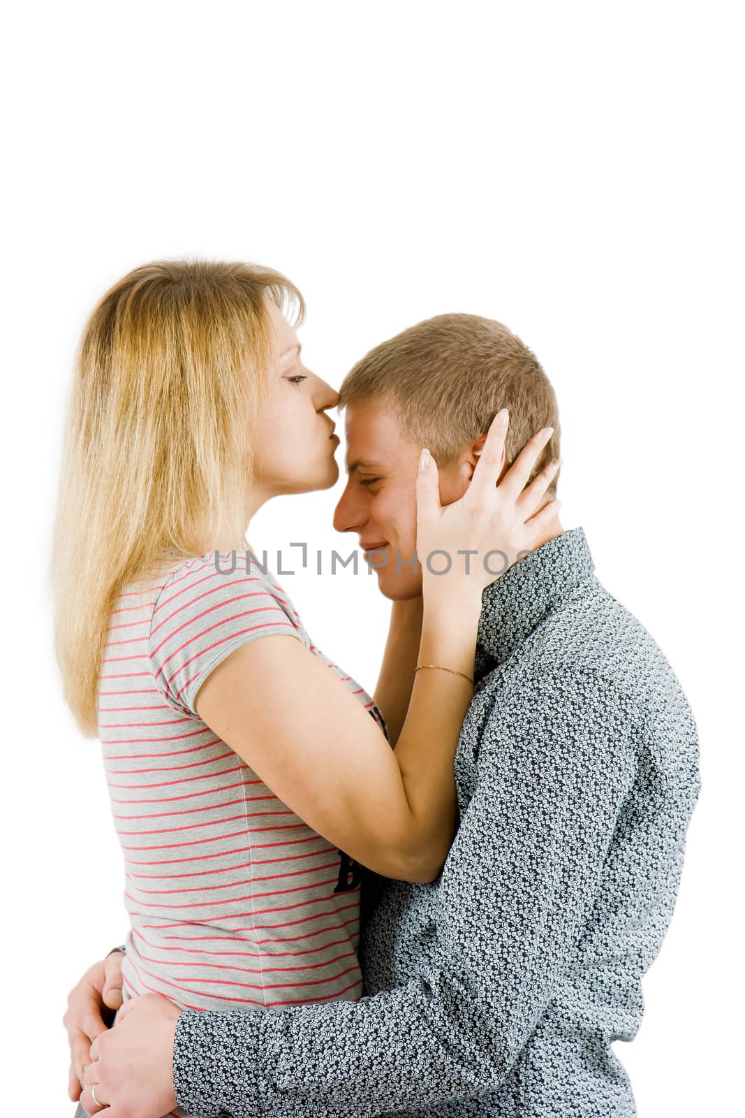 girl kissing a man in a forehead on an isolated white background
