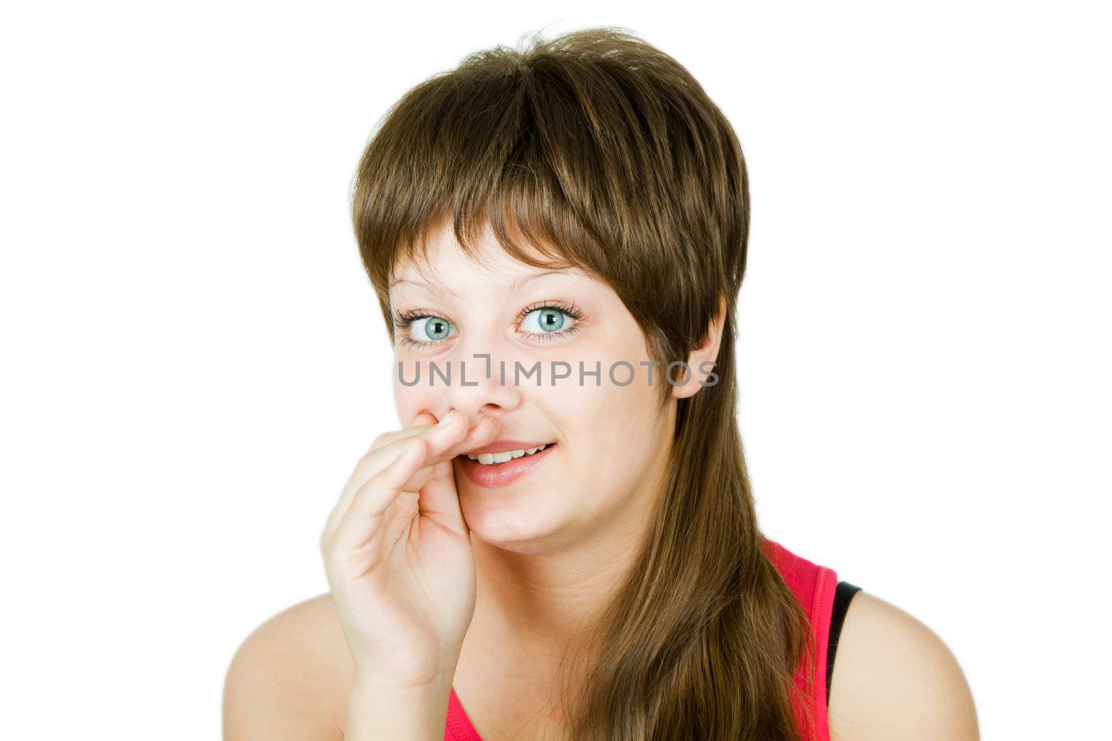 girl on an isolated background with his hand to his mouth
