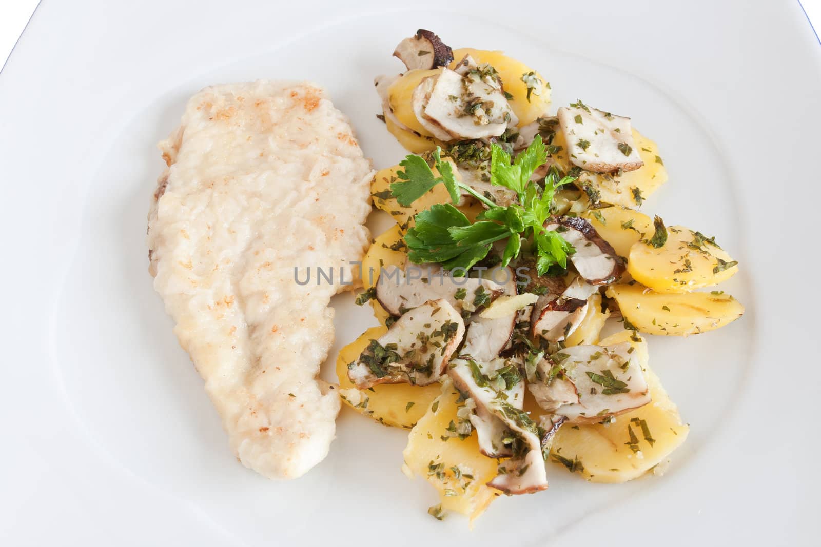 chicken escalope with baked potatoes and mushrooms isolated on white with clipping path