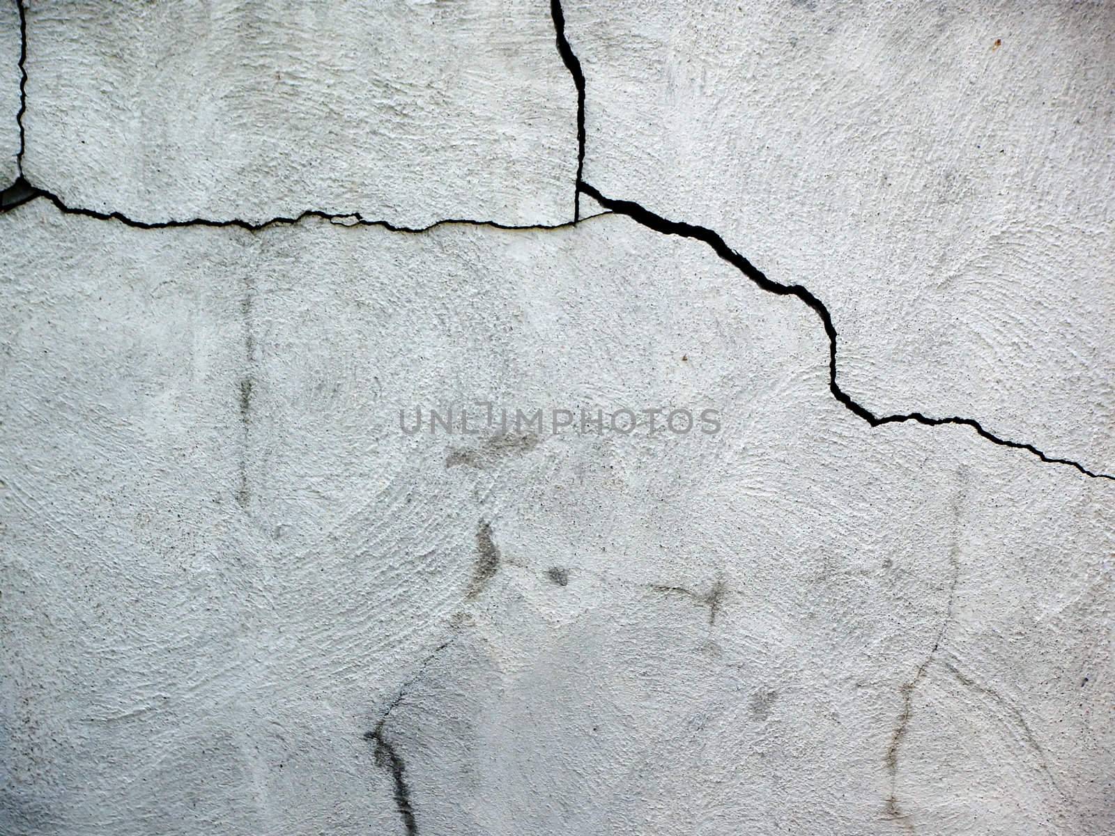 Close up on damaged cracked house fondation made of cement blocks.               