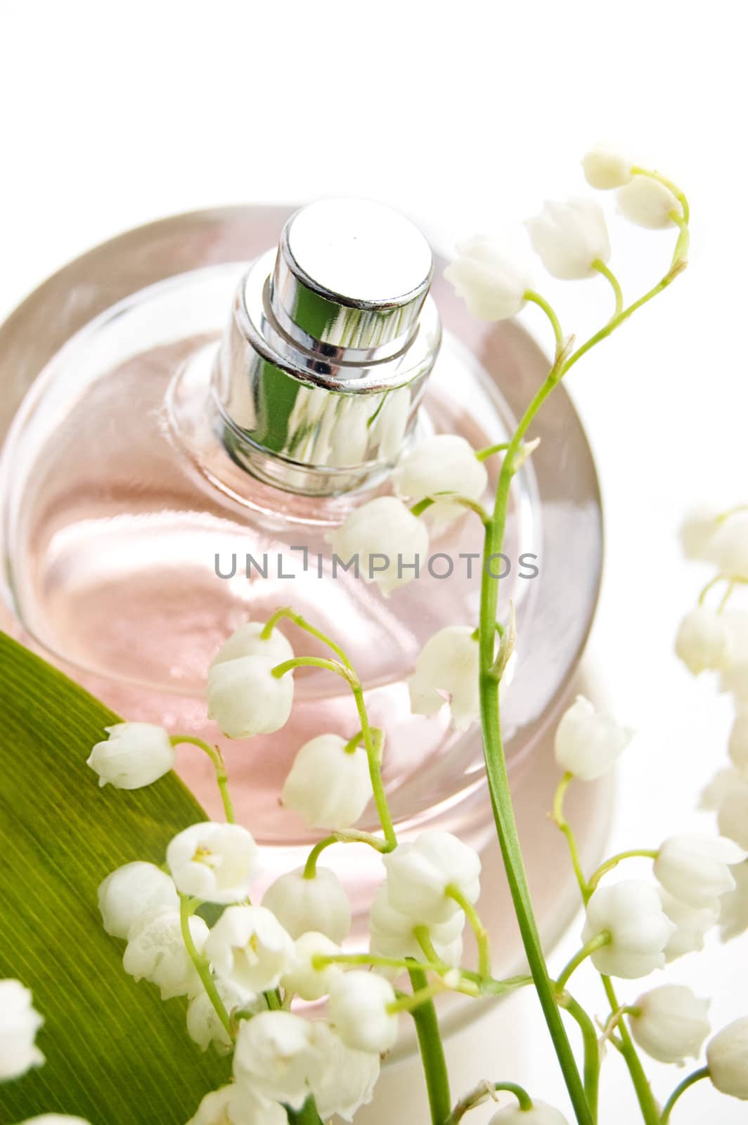 Bottle of perfume and lilies-of-the-valley