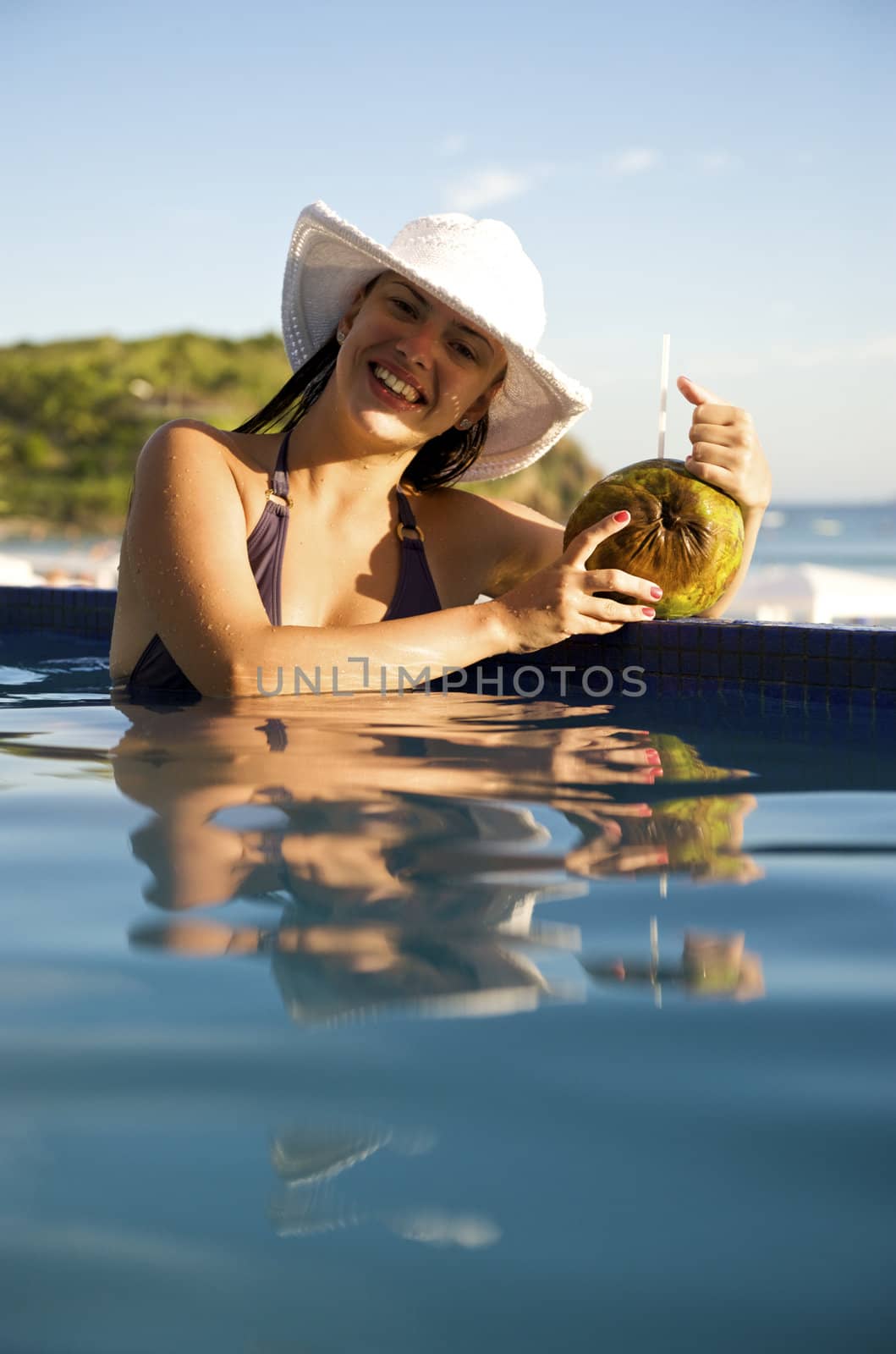 Woman enjoying the swimming pool in Buzios, rio de Janeiro, Brazil