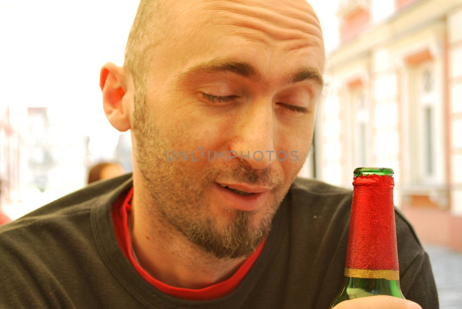 Young man drinking from a bottle of beer