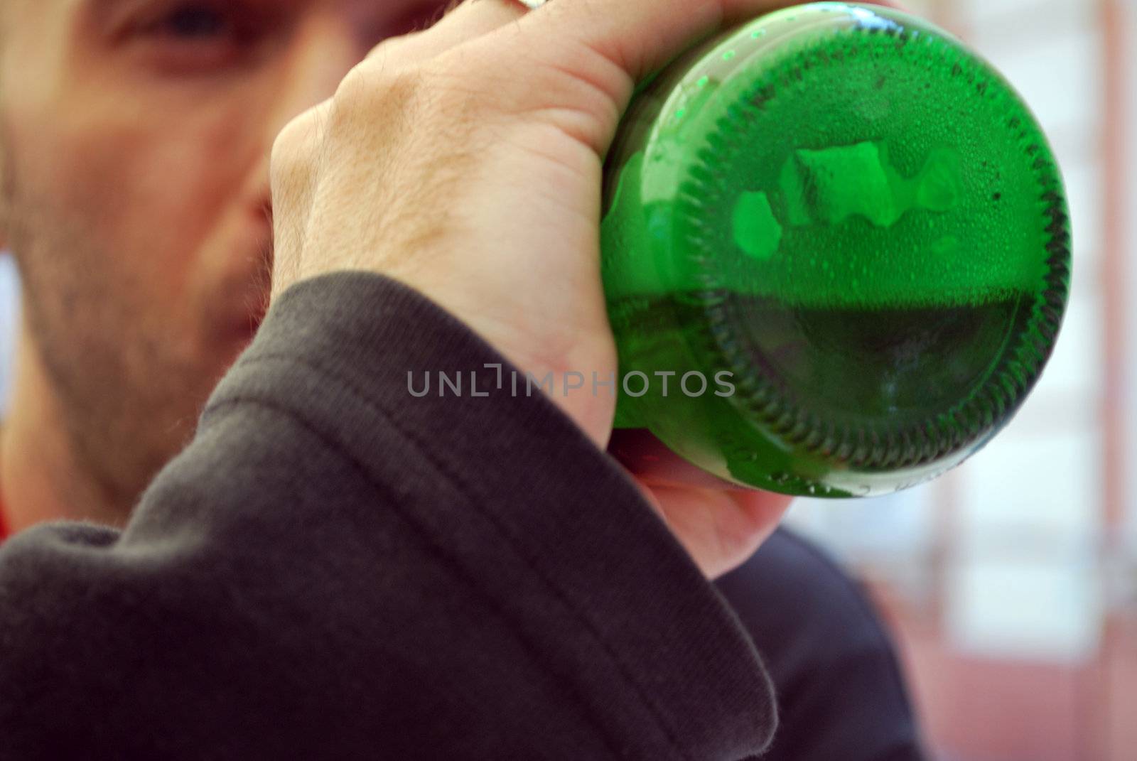 Young man drinking from a bottle of beer