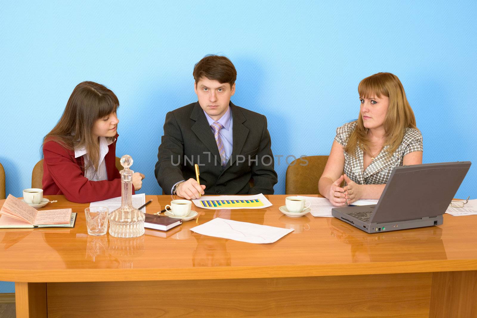 Business team sits at the big table