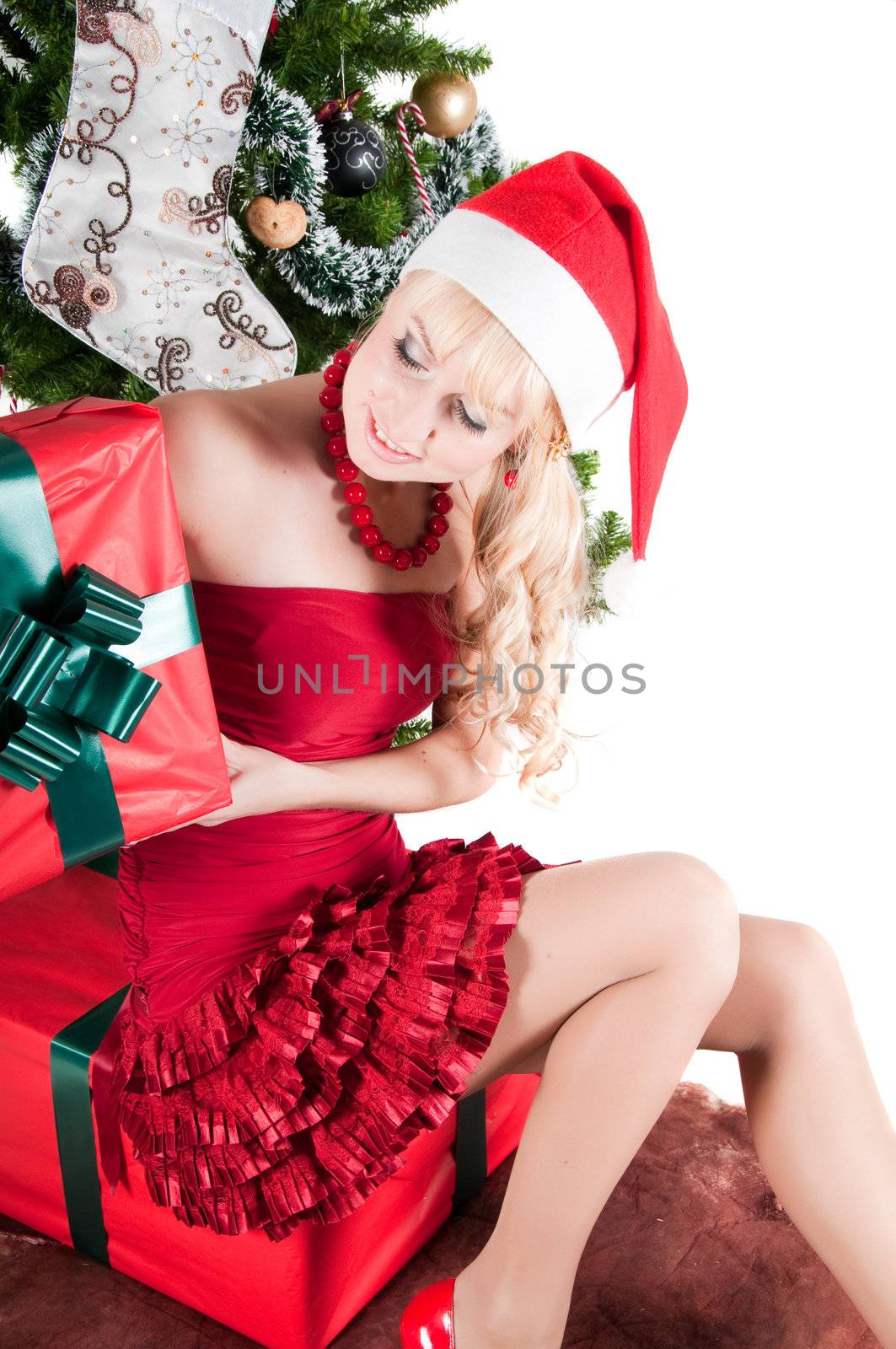 Happy woman with Christmas presents and tree isolated on white