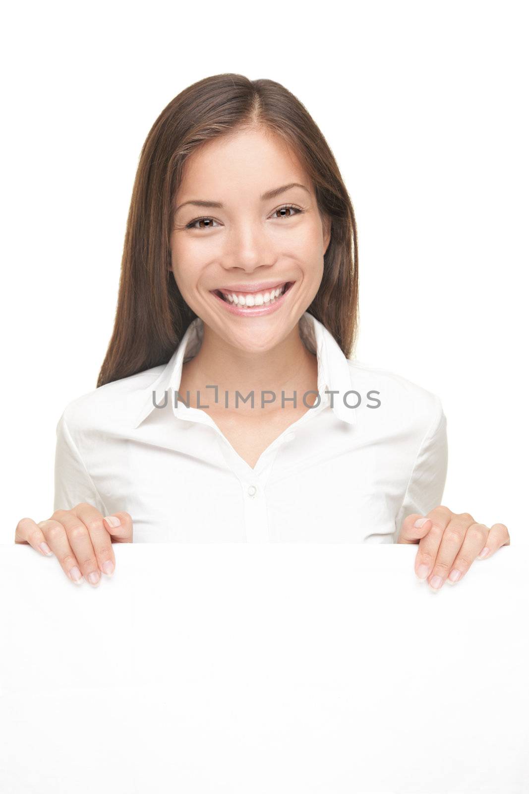 Smiling friendly young woman showing white blank sign with copyspace. Isolated on white background