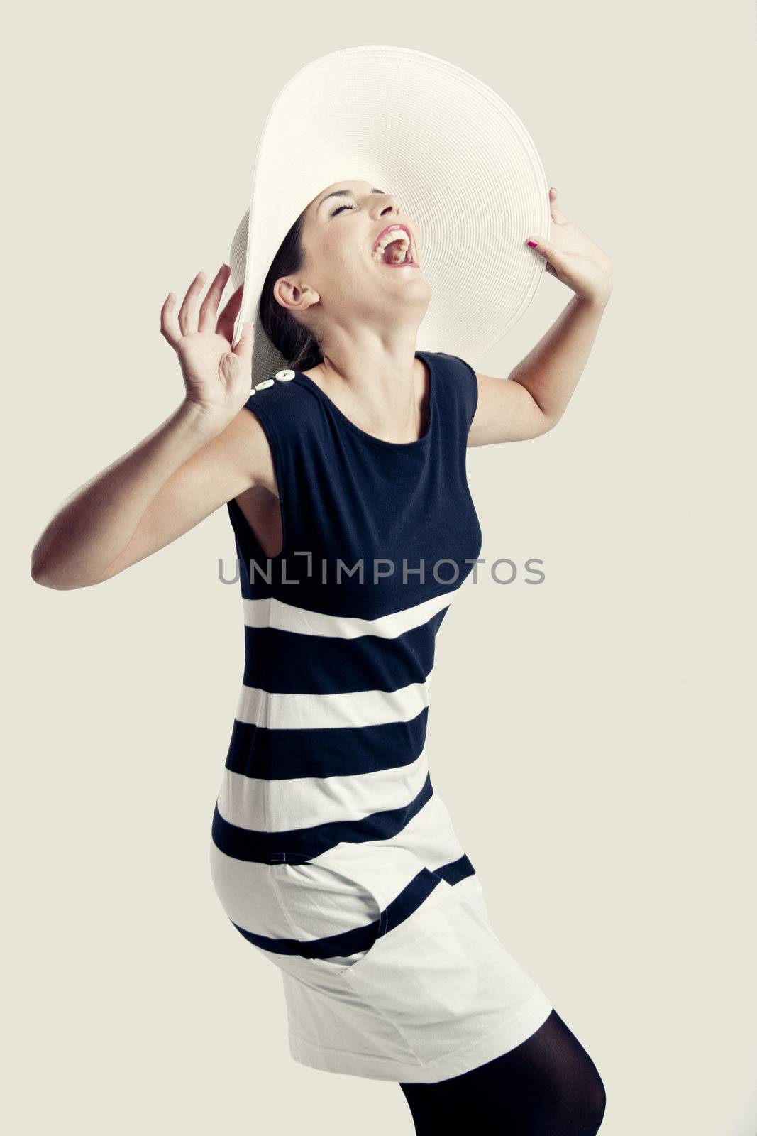 Portrait of a beautiful fashion woman posing with a hat