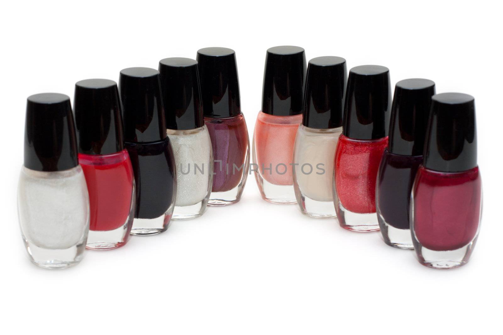Group of nail polishes. Close-up. Over white.