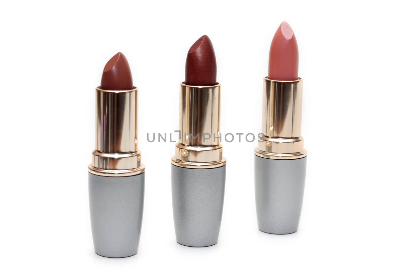 Three feminine lipsticks, tubeses insulated on white background