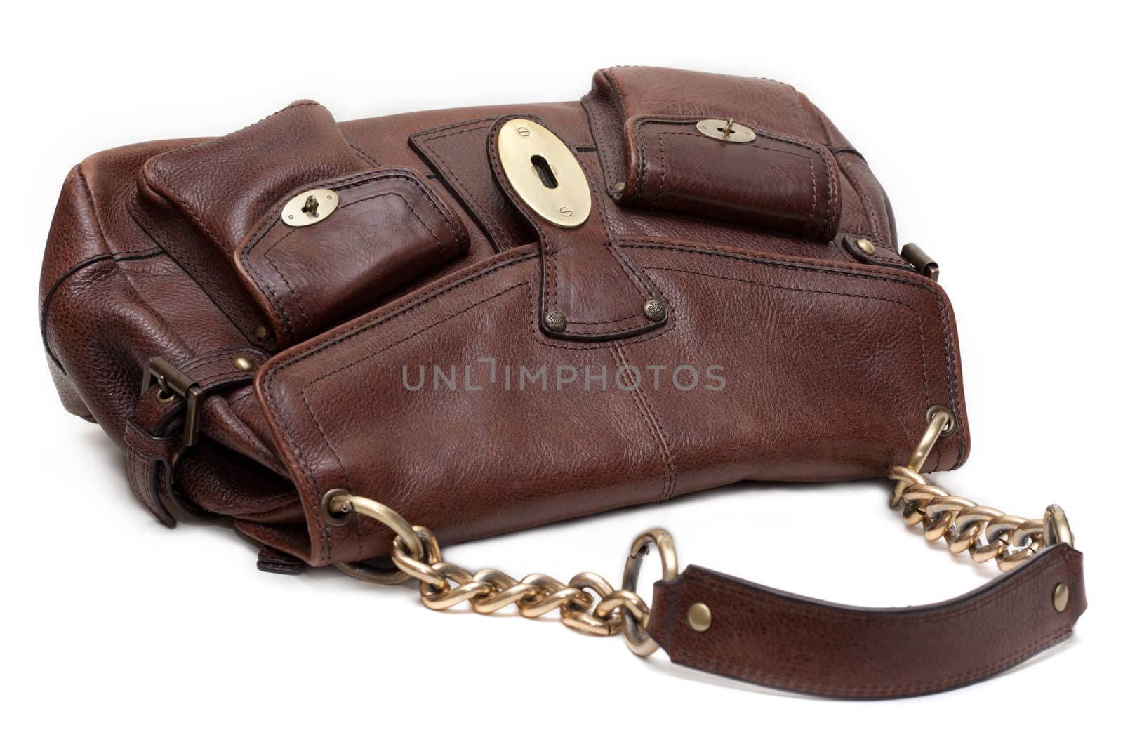 Beautiful brown leather feminine bag with golden chain-handle and lock insulated on white background