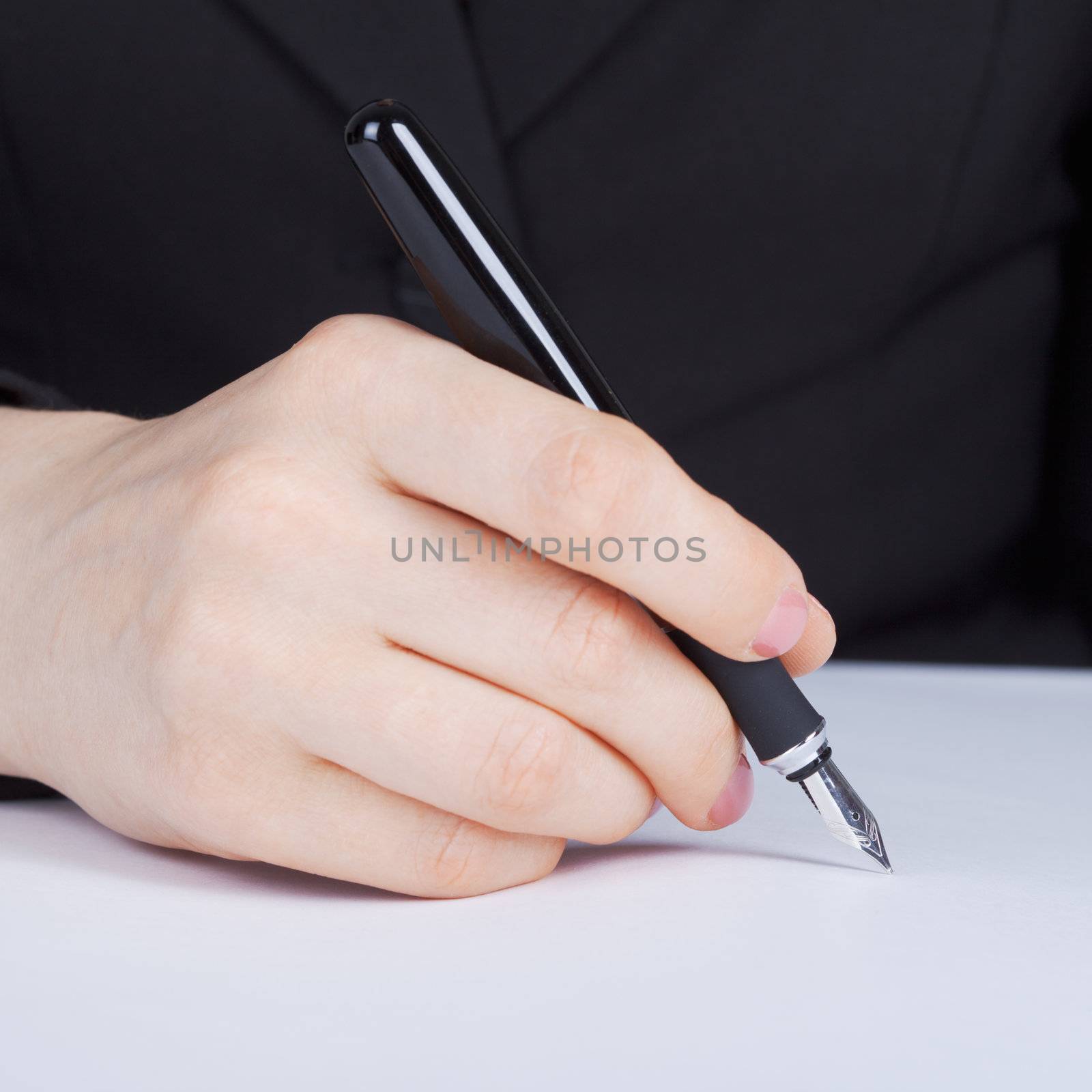 Female hand holding a fountain pen with a silver pen
