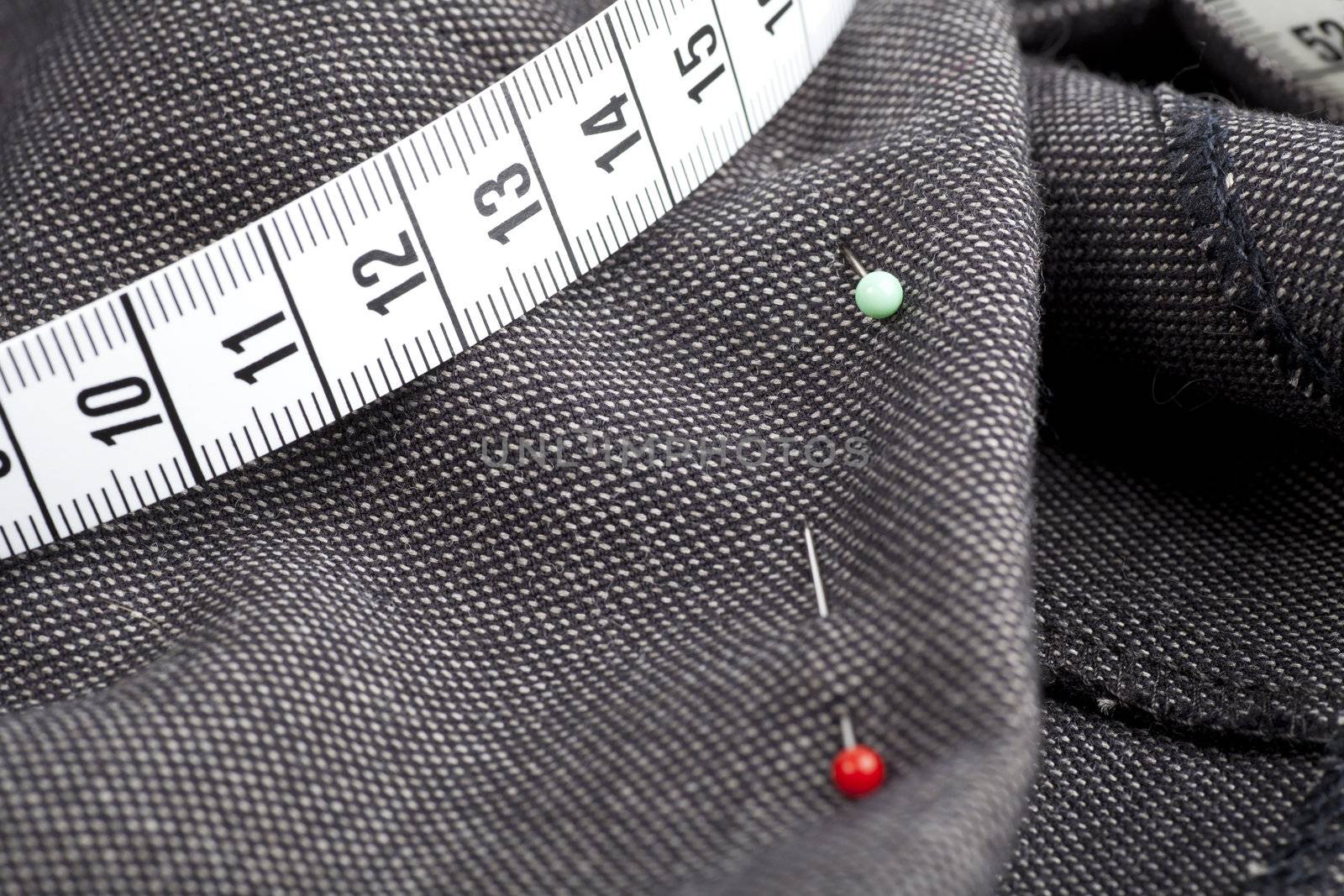 Pins and measuring tape on fabric, ready for sewing.