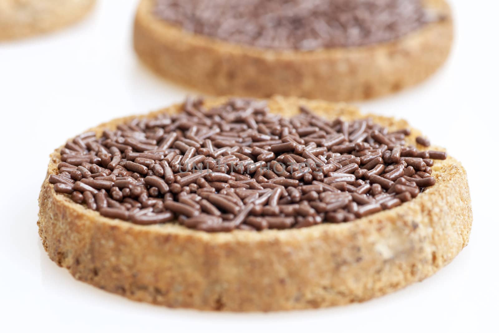 Dutch "hagelslag"  chocolate sprinkles with butter on round toast.