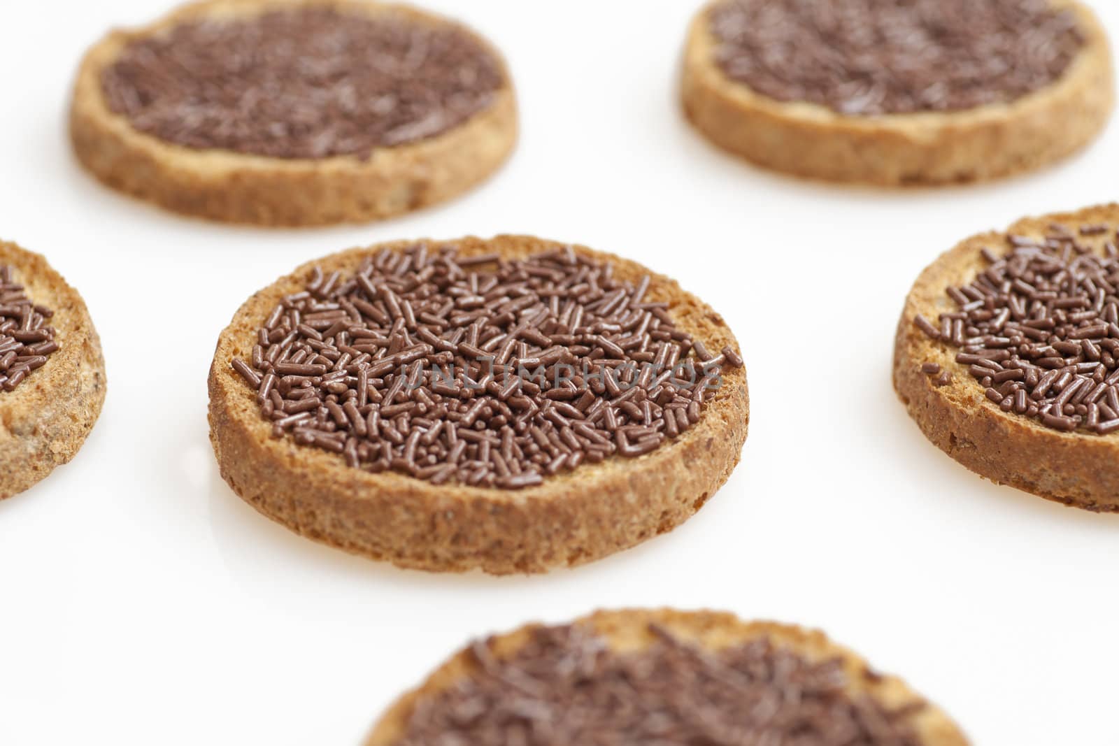 Dutch "hagelslag"  chocolate sprinkles with butter on round toast.