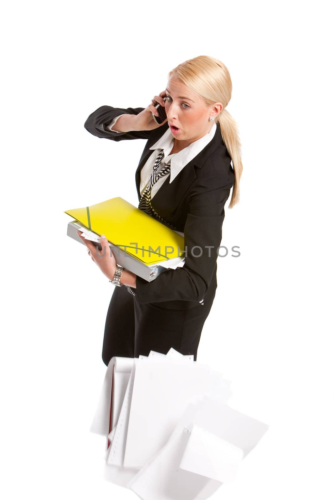 Businesswoman on the phone trying to juggle her papers 
