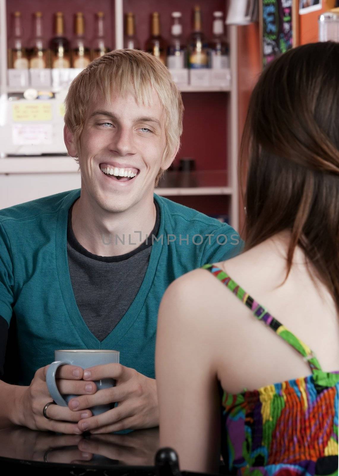 Young man with female friend in a coffee house