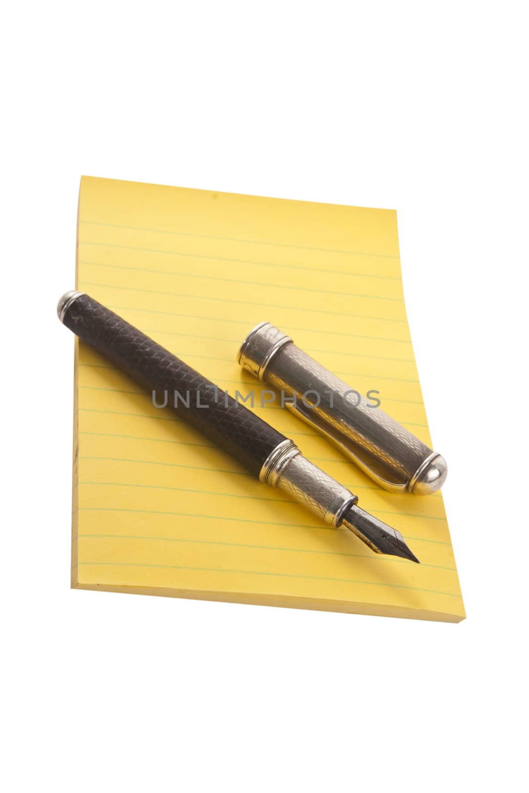 Yellow notepad with fountain pen, isolated on white background