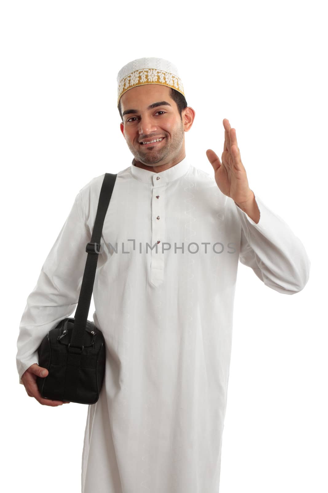 A man wearing a beautiful embroidered robe, thobe, kurta outfit fastened with ruby buttons and wearing a decorative topi hat.  He is waving in a friendly manner.  White background.