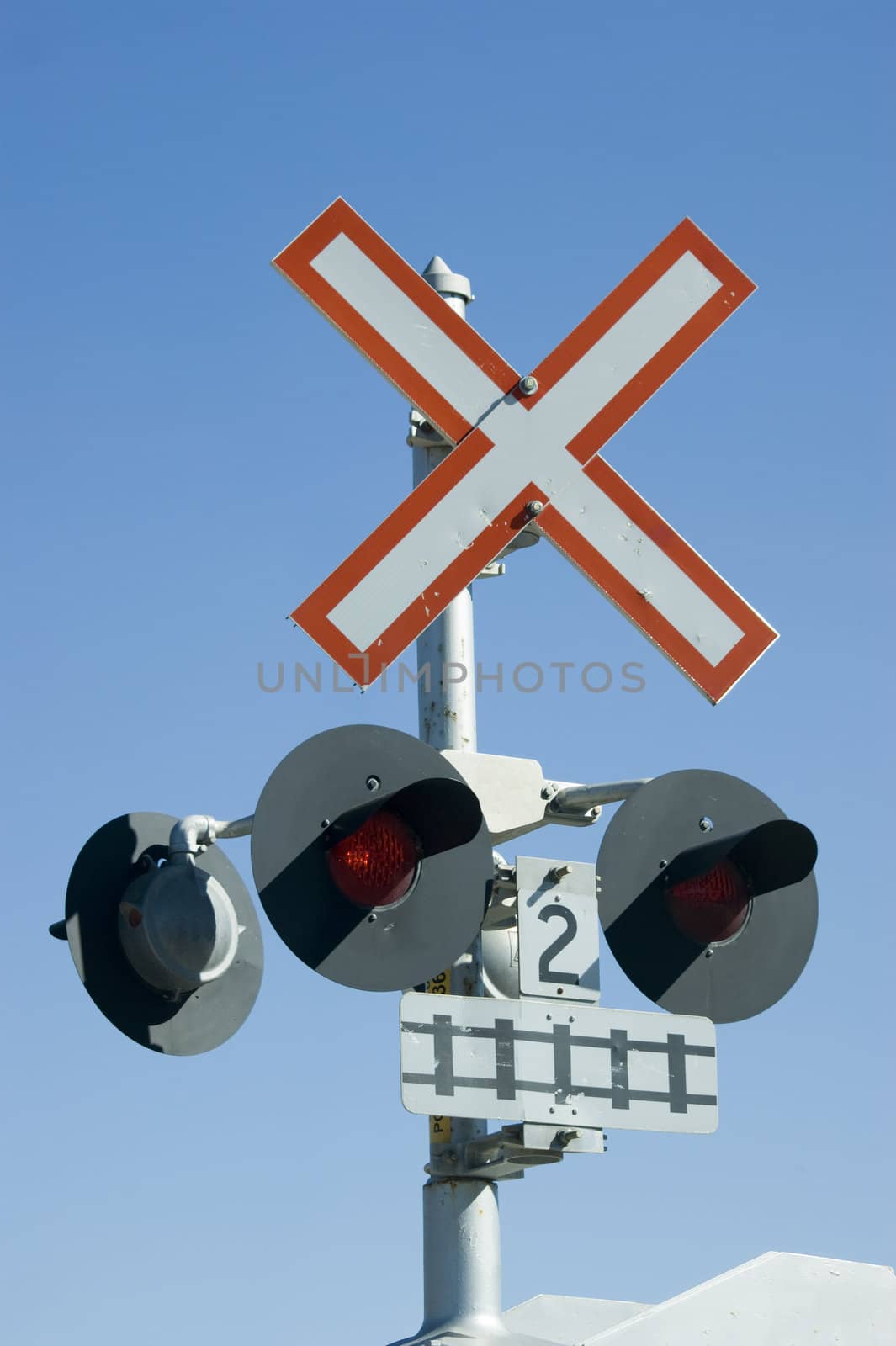 Railway cross sign isolated against blue sky