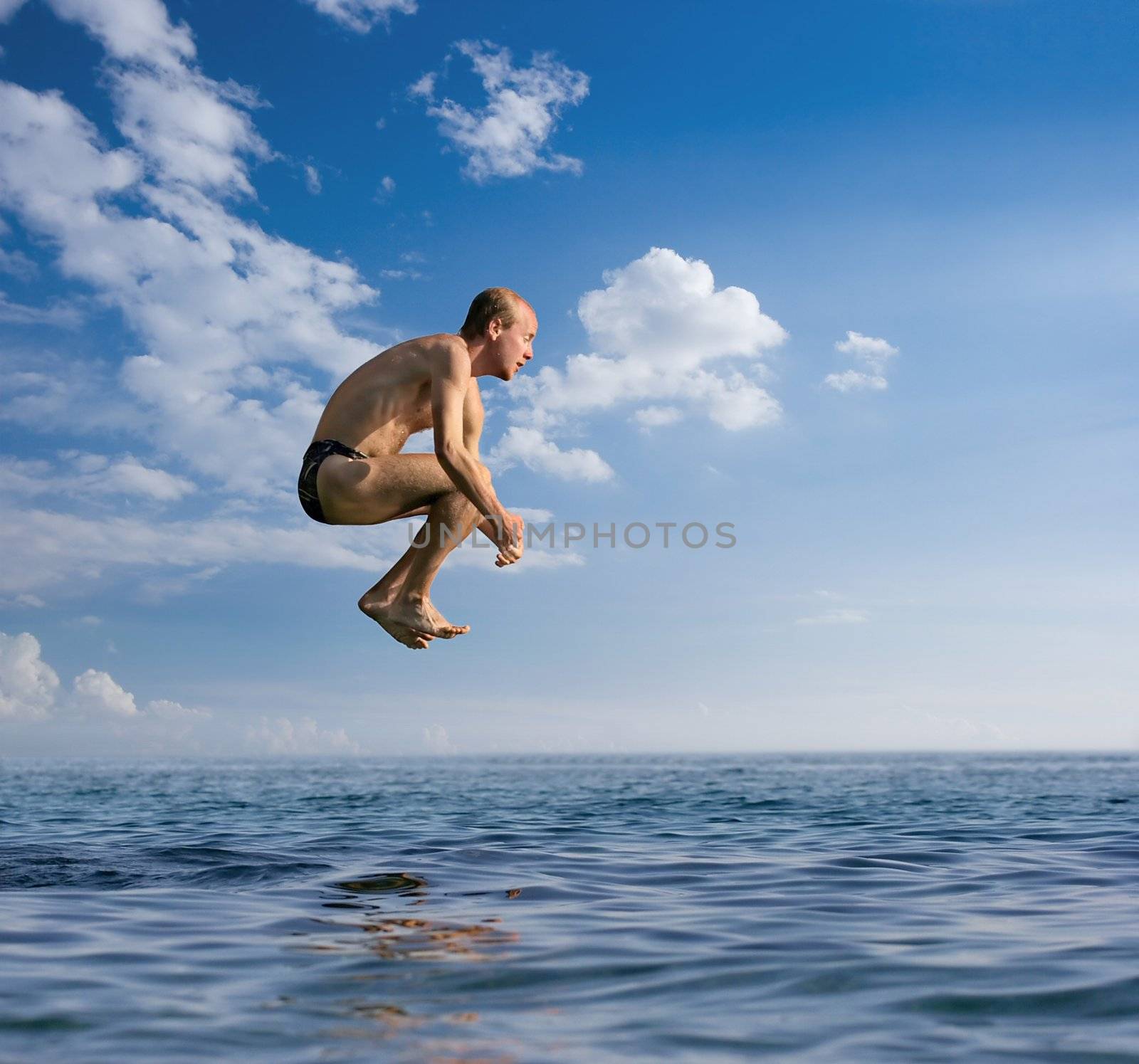 Man jumping into the see from a height