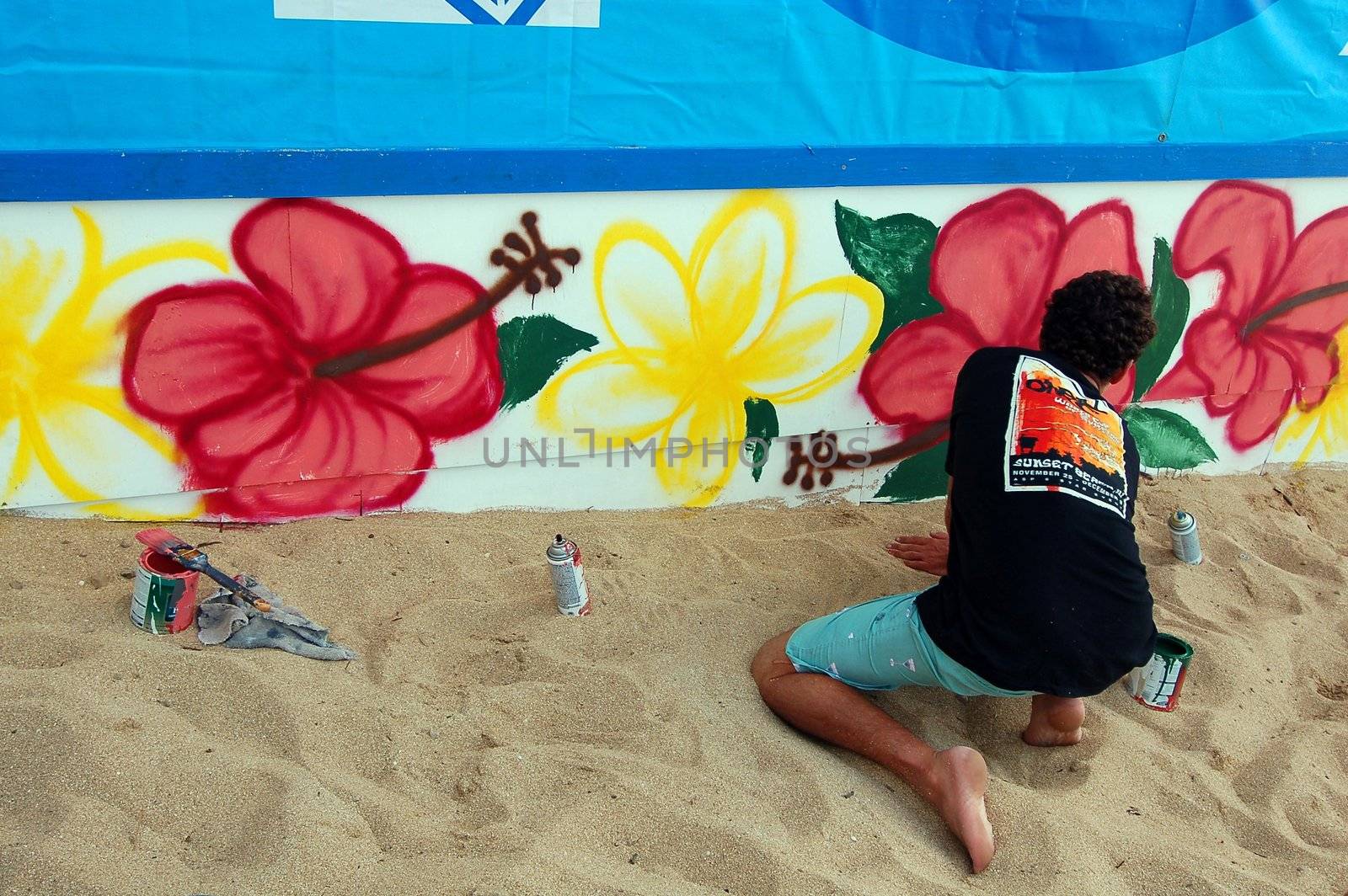 An artist painting on his canvas at the beach