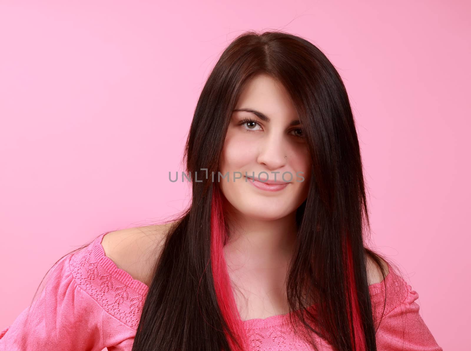 portrait of a cute caucasian long hair girl, pink background