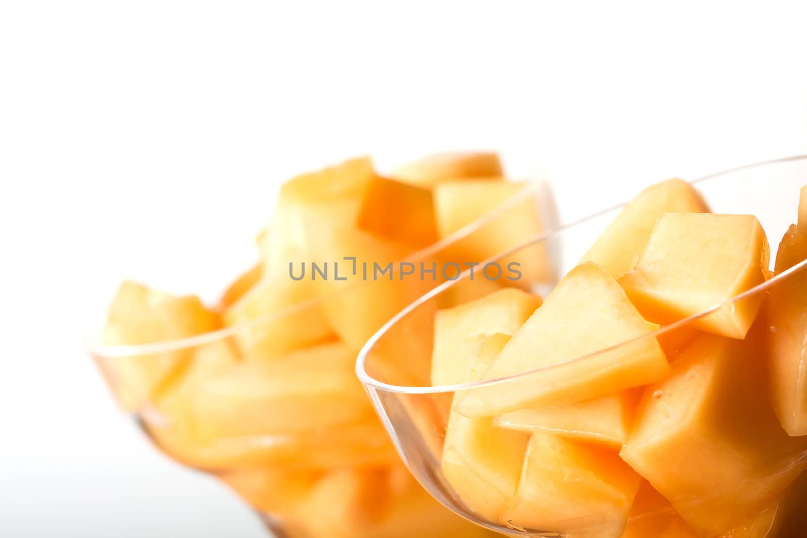 cantaloupe cut and in parfait glass light background